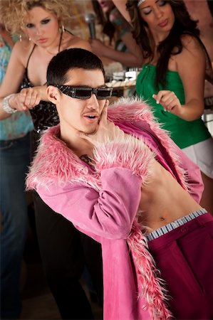 funny retro groups - Handsome Asian man in fluffy pink coat at a 1970's disco party Stock Photo - Budget Royalty-Free & Subscription, Code: 400-04691154