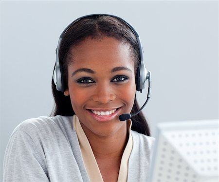 Charismatic businesswoman using headset at her desk in the office Stock Photo - Budget Royalty-Free & Subscription, Code: 400-04691227
