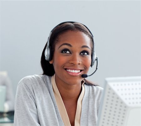 Delighted businesswoman using headset at her desk in the office Stock Photo - Budget Royalty-Free & Subscription, Code: 400-04691228