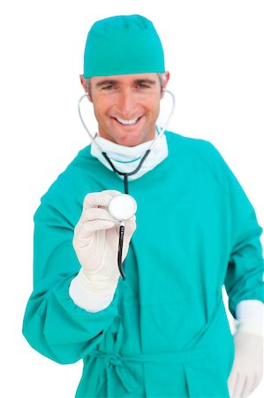 doctor with cap and mask - Charismatic surgeon holding a stethoscope against a white background Stock Photo - Budget Royalty-Free & Subscription, Code: 400-04691683