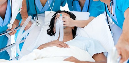 simsearch:400-04198266,k - Patient seriously injured supported by a medical team against white back ground Stockbilder - Microstock & Abonnement, Bildnummer: 400-04692279