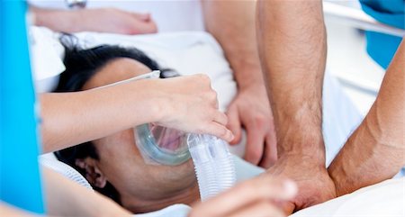 simsearch:400-04198266,k - Medical team giving oxygen mask to the patient in the hospital Stockbilder - Microstock & Abonnement, Bildnummer: 400-04692280