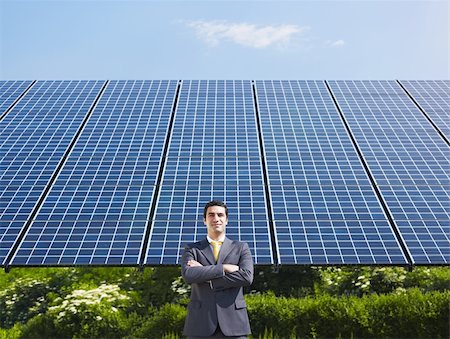 Portrait of mid adult italian male engineer with arms folded in solar power station, smiling at camera.Horizontal shape, front view. Copy space Stock Photo - Budget Royalty-Free & Subscription, Code: 400-04692657