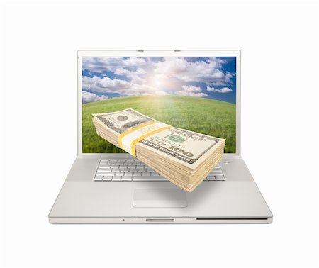 simsearch:400-04641104,k - Silver Computer Laptop Isolated on White with Stacks of Hundred Dollar Bills Extruding the Screen. Stockbilder - Microstock & Abonnement, Bildnummer: 400-04692826