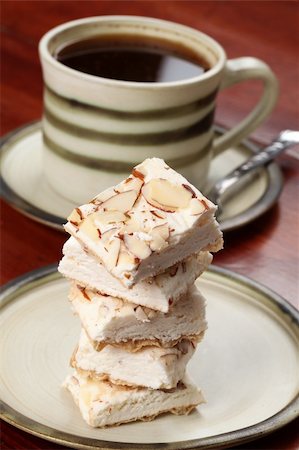 A confectionary similar to the hard variety of the Spanish turron and Italian torrone produced in the Czech Republic. It is called "Turecky med" - literally "Turkish honey" and it is made from egg white, honey and various kinds of nuts. Fotografie stock - Microstock e Abbonamento, Codice: 400-04693354