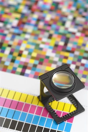 prova (evidenza) - Shallow depth of field image of a printers loupe on printed sheet.  Focus is on the top of the loupe. Fotografie stock - Microstock e Abbonamento, Codice: 400-04693849