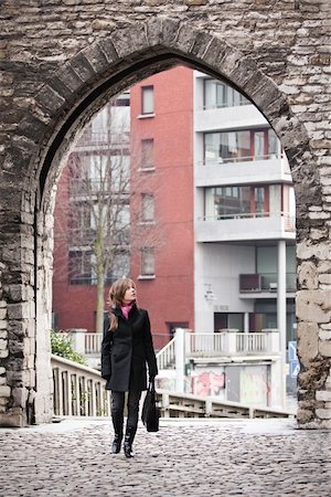 Woman walking in old city Stock Photo - Budget Royalty-Free & Subscription, Code: 400-04693985