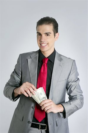 Businessman young with dollar notes suit and tie on gray background Stock Photo - Budget Royalty-Free & Subscription, Code: 400-04704761