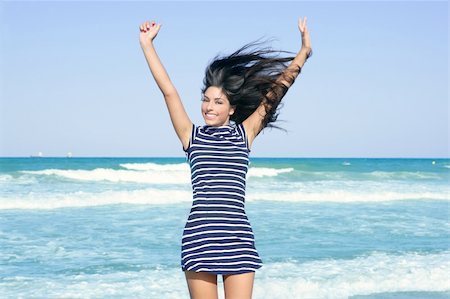 simsearch:400-04123668,k - Beautiful summer brunette girl jumping on the blue beach Stock Photo - Budget Royalty-Free & Subscription, Code: 400-04704773