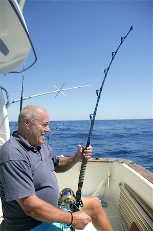 Angler elderly big game sport fishing boat blue summer sea sky Stock Photo - Budget Royalty-Free & Subscription, Code: 400-04704790