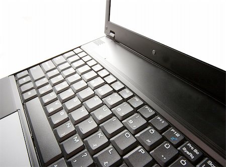 Black laptop closeup on white background Stock Photo - Budget Royalty-Free & Subscription, Code: 400-04705801