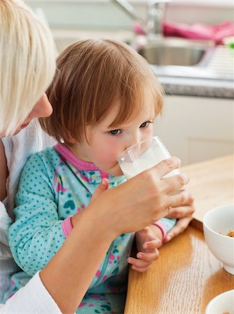 excited kids eating cereal - Beauty mother and daughter having breakfast in kitchen Stock Photo - Budget Royalty-Free & Subscription, Code: 400-04705824