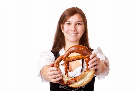 simsearch:400-07087495,k - Young woman with Bavarian dirndl holding Oktoberfest pretzel. Isolated on white background. Stock Photo - Budget Royalty-Free & Subscription, Code: 400-04706051