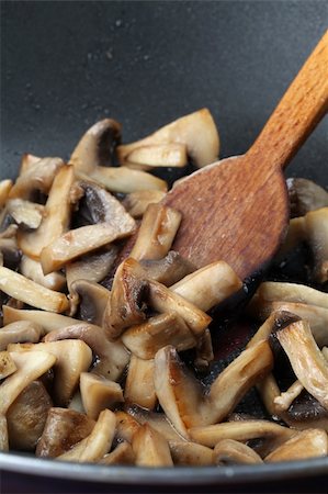 Fried mushrooms in a wok. Shallow dof Stock Photo - Budget Royalty-Free & Subscription, Code: 400-04707322