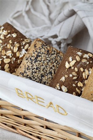 simsearch:400-04699541,k - Basket with different kinds of wholemeal bread. Focus on the embroidered word "bread" on the basket. Foto de stock - Super Valor sin royalties y Suscripción, Código: 400-04707354