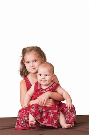 simsearch:400-05739745,k - Big sister holding little sister. White background. Stock Photo - Budget Royalty-Free & Subscription, Code: 400-04707574