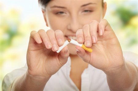 stop smoking - Young woman breaking cigarette over white background Stock Photo - Budget Royalty-Free & Subscription, Code: 400-04708337