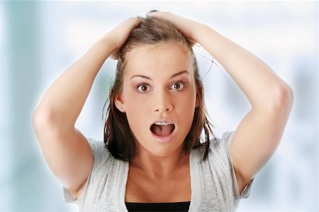 portrait screaming girl - Young woman shocked. Isolated on white background Stock Photo - Budget Royalty-Free & Subscription, Code: 400-04708339