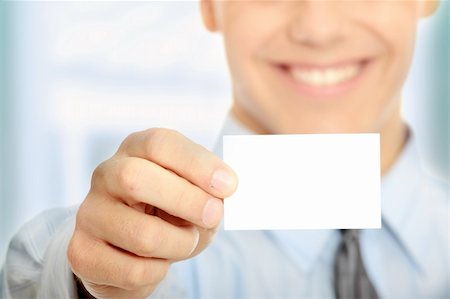 simsearch:400-05718318,k - Young happy smiling successful business man with blank business card or sign Foto de stock - Super Valor sin royalties y Suscripción, Código: 400-04708424