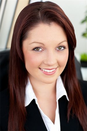 simsearch:400-04187842,k - Charismatic businesswoman smiling at the camera sitting in her office Stock Photo - Budget Royalty-Free & Subscription, Code: 400-04708472