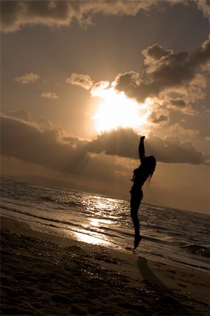 Girl jumping on sunrise at the beach Stock Photo - Budget Royalty-Free & Subscription, Code: 400-04708643