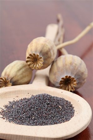 Poppy seeds on a wooden spoon and poppy heads Stock Photo - Budget Royalty-Free & Subscription, Code: 400-04709494