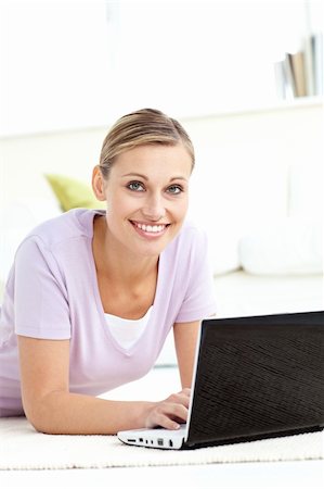 simsearch:400-04709946,k - Charming woman using her computer lying on the floor in the living room Stockbilder - Microstock & Abonnement, Bildnummer: 400-04709970