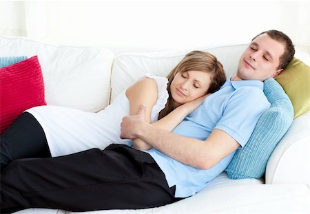 simsearch:400-06415374,k - Relaxed couple sleeping on the sofa in the living room Stock Photo - Budget Royalty-Free & Subscription, Code: 400-04709985