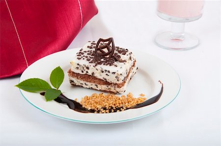 simsearch:400-04322996,k - Sweet chocolate dessert with nuts and chocolate on white plate and red napkin Foto de stock - Royalty-Free Super Valor e Assinatura, Número: 400-04700019