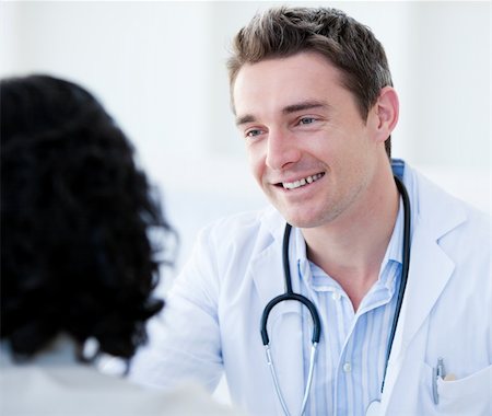 Portrait of a handsome doctor talking with his patient for the annual check-up in the hospital Stock Photo - Budget Royalty-Free & Subscription, Code: 400-04700056