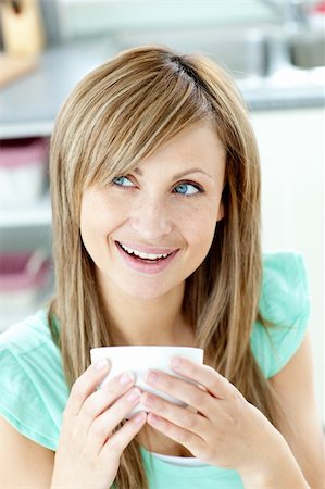 simsearch:400-04335902,k - Delighted woman drinking a coffee at home Stock Photo - Budget Royalty-Free & Subscription, Code: 400-04700292