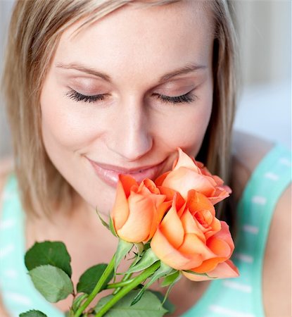 face with rose - Smiling woman smelling roses at home Stock Photo - Budget Royalty-Free & Subscription, Code: 400-04700383