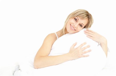 simsearch:400-05729351,k - Smiling woman hugging her pillow on her bed Photographie de stock - Aubaine LD & Abonnement, Code: 400-04700541