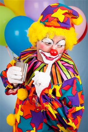 drunk man dressed up - Alcoholic clown gets caught sneaking a drink from his flask. Stock Photo - Budget Royalty-Free & Subscription, Code: 400-04700597