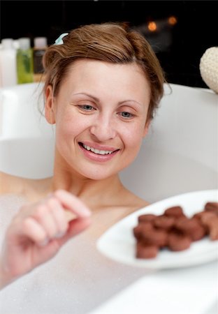 Bright woman eating chocolate while having a bath in a spa center Stock Photo - Budget Royalty-Free & Subscription, Code: 400-04702384
