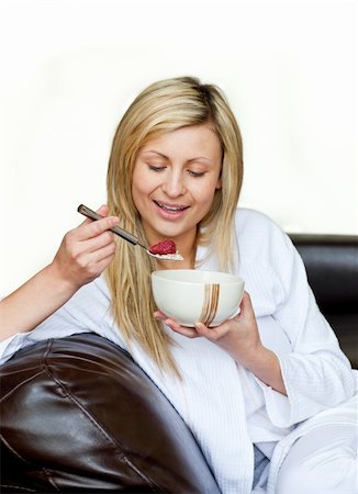 simsearch:400-04708507,k - Cheerful woman having a breakfast against a white background Stock Photo - Budget Royalty-Free & Subscription, Code: 400-04702395