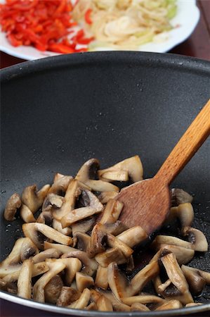 Fried mushrooms in a wok. Shallow dof Stock Photo - Budget Royalty-Free & Subscription, Code: 400-04702492