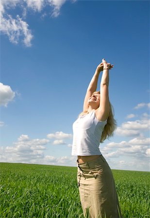 simsearch:400-04982004,k - Young happy woman in field under blue sky Stock Photo - Budget Royalty-Free & Subscription, Code: 400-04702506