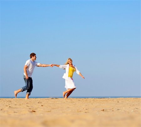 simsearch:400-04702706,k - Happy, fresh young couple enjoy a day on the beach together Stockbilder - Microstock & Abonnement, Bildnummer: 400-04702688