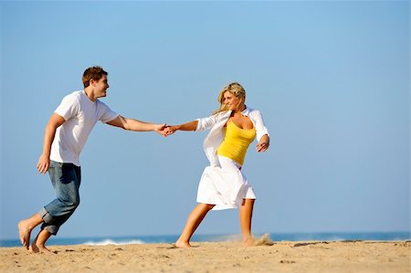 simsearch:400-04702706,k - Happy, fresh young couple enjoy a day on the beach together Stockbilder - Microstock & Abonnement, Bildnummer: 400-04702689