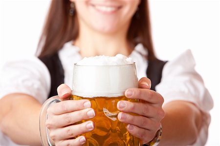 /Closeup macro of Oktoberfest beer stein with woman in babackground. Isolated on white. Stock Photo - Budget Royalty-Free & Subscription, Code: 400-04703790