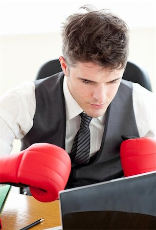 Ambitious businessman wearing boxing gloves in the office Stock Photo - Budget Royalty-Free & Subscription, Code: 400-04703892