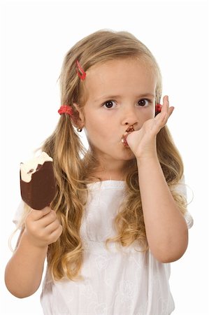 Little girl eating ice cream, licking her finger - isolated Foto de stock - Super Valor sin royalties y Suscripción, Código: 400-04714150