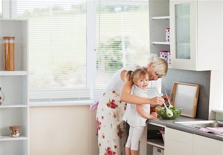 simsearch:640-01357998,k - Jolly girl preparing a salad with her mother in the kitchen Stock Photo - Budget Royalty-Free & Subscription, Code: 400-04714576