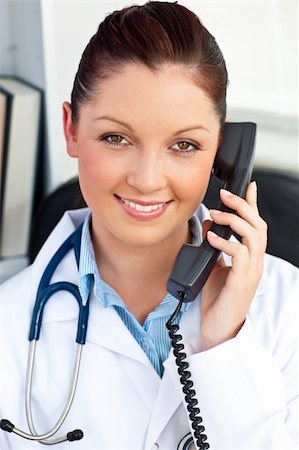 simsearch:400-04704005,k - Smiling female doctor talking on phone in her office Stock Photo - Budget Royalty-Free & Subscription, Code: 400-04714594