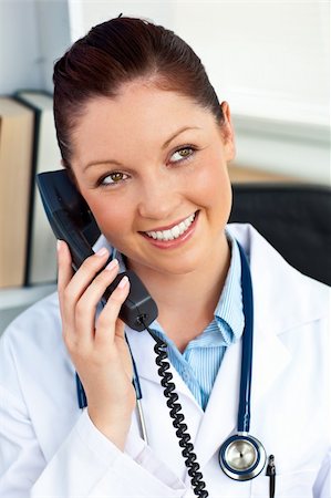 simsearch:400-04704005,k - Delighted female doctor talking on phone in her office Stock Photo - Budget Royalty-Free & Subscription, Code: 400-04714593