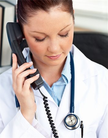 simsearch:400-04704005,k - Portrait of a serious female doctor phoning in her office sitting at her desk Stock Photo - Budget Royalty-Free & Subscription, Code: 400-04714613