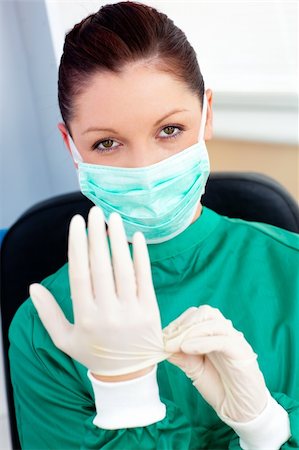 speculum - Sophisticated surgeon wearing scrubs and a mask looking at the camera in a hospital Stock Photo - Budget Royalty-Free & Subscription, Code: 400-04714651