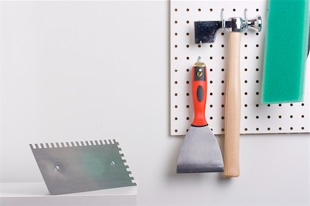 drywall - Tools used for wall plastering hanging on a pegboard. Stock Photo - Budget Royalty-Free & Subscription, Code: 400-04715209