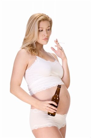 pregnant smoking pictures - Unhealthy habits during pregnancy - tobacco and alcohol. Attractive Caucasian blond female in white lingerie holding bottle of beer and smoking cigarette Stock Photo - Budget Royalty-Free & Subscription, Code: 400-04715223